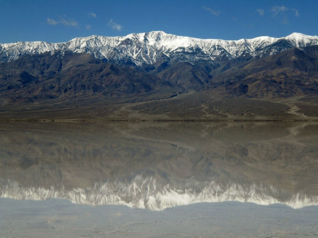 This beautiful shot of Lake Manly shows Telescope Peak towering above the lake and reflecting on it: