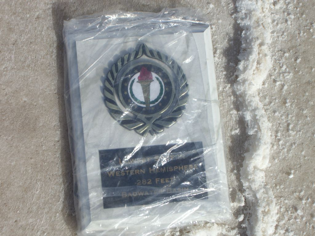 This Lowest Point plaque once marked the location.  Notice that it is wrapped up in a clear plastic bag to protect it: