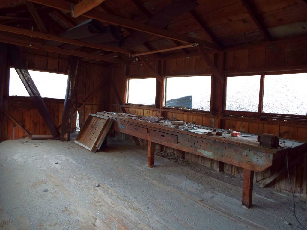 Inside the workshop, not much remains except the work table and some odds and ends: