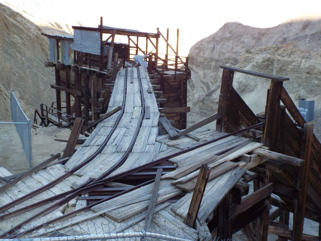 Rail tracks emerge from the adits in order to dump the ore into the chutes for processing:
