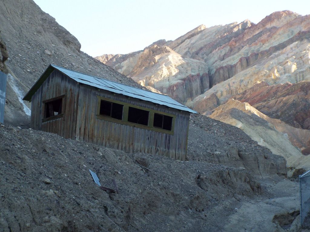The workshop (or cabin) with colorful mountains in the background: