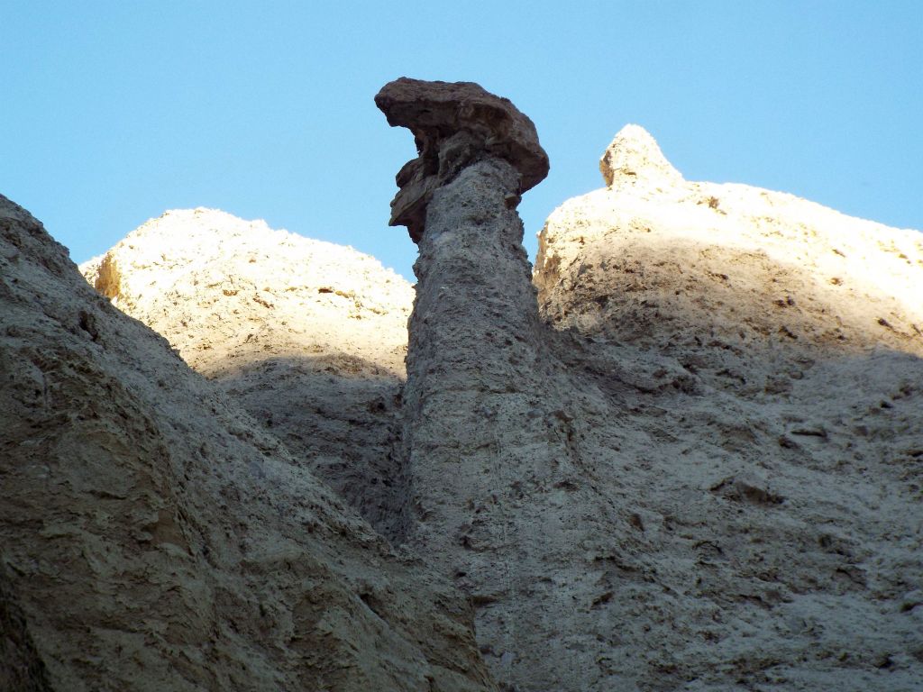 A rock-topped pinnacle rising high above the canyon walls: