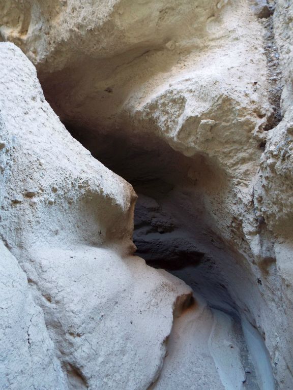 Entering one of the darkest bends of the slot which has been created by a massive overhang: