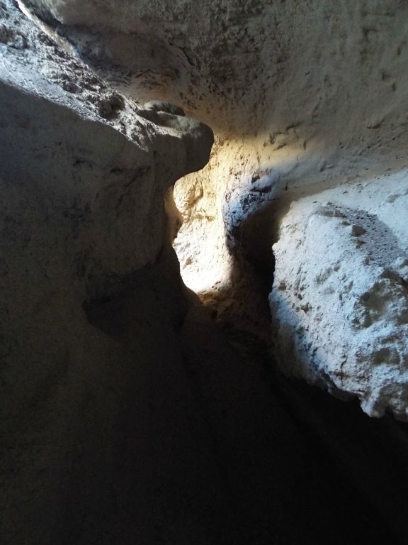 Three pictures showing the mixture of light and shadows through the overhanging section of curving slot: