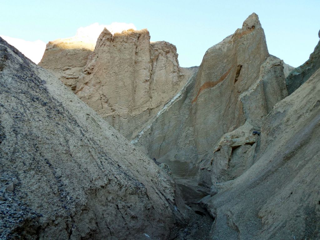 Jagged formations with sharp edges rise high above the canyon: