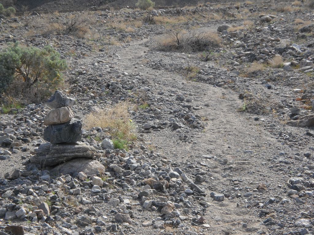 Cairns marked the spot where the old road continues but has now become just a path: