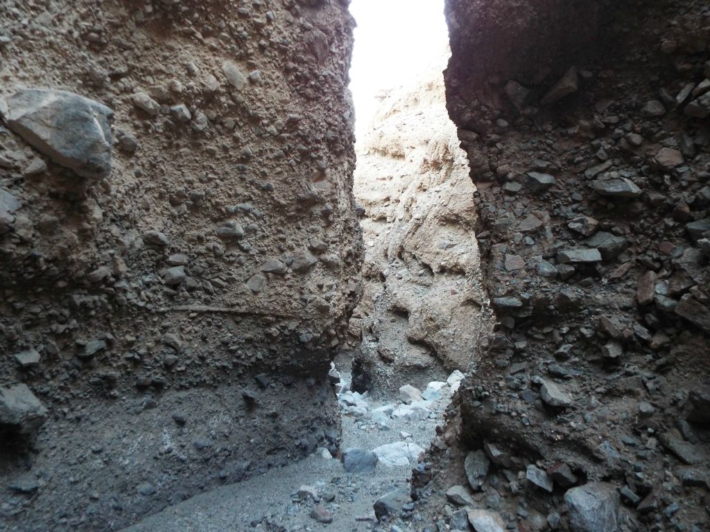 Two pictures showcasing a shallow wash with quick canyon turns: