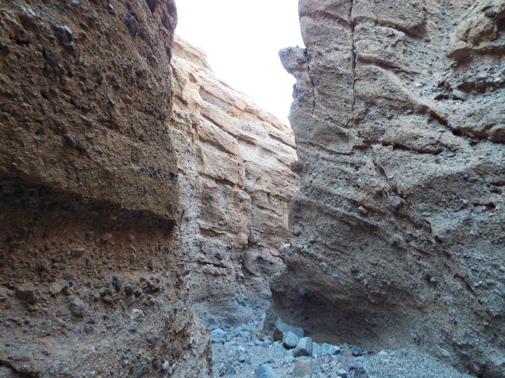 Cracks and indentations in the conglomerate rock walls: