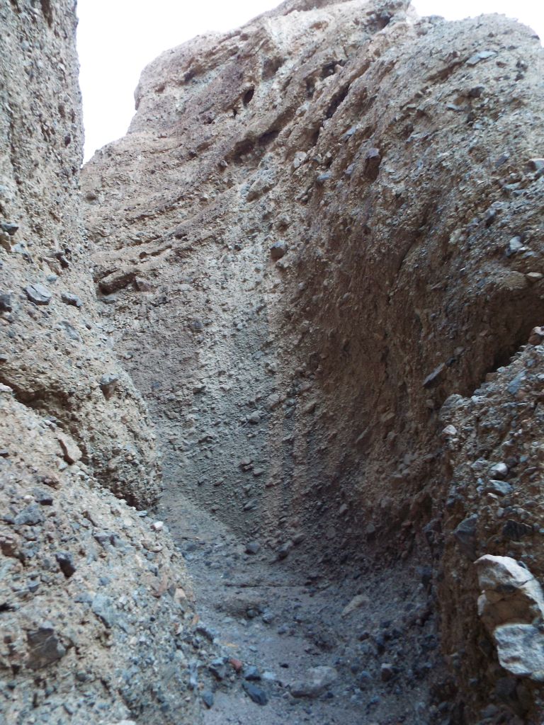 A steep uphill bend to the left where the right side wall rises up high: