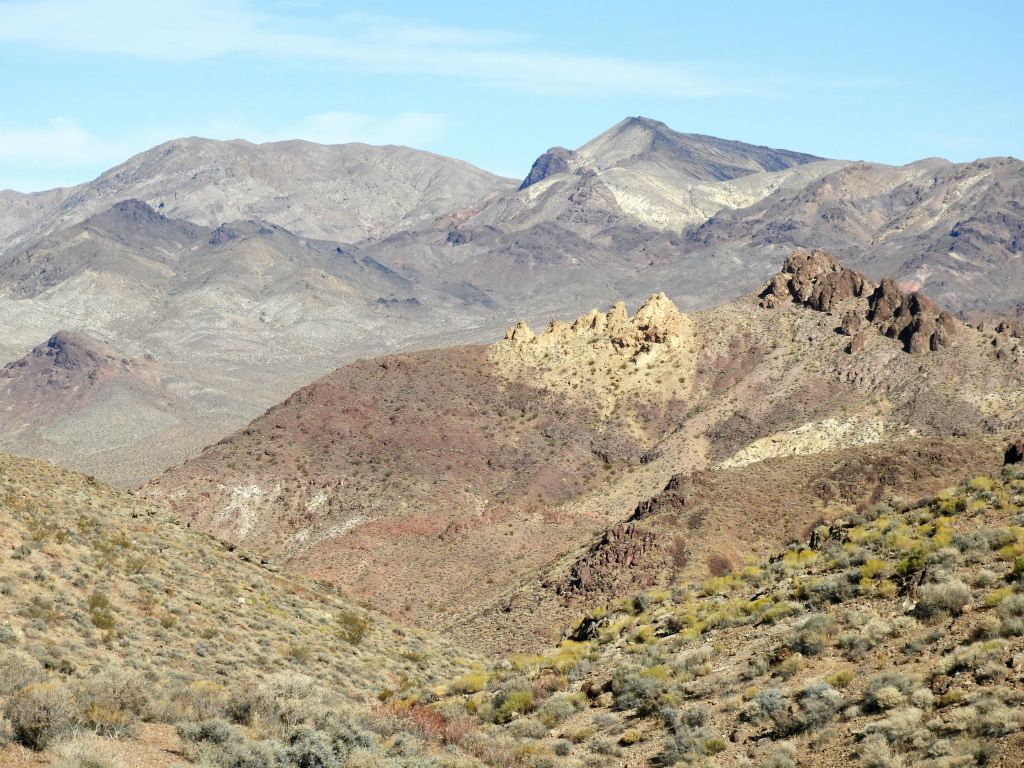 Zooming in, some colorful rock formations are visible on the closer hillside, while the distinct shape of Funeral Peak (6,384 feet) can be seen at the background middle: