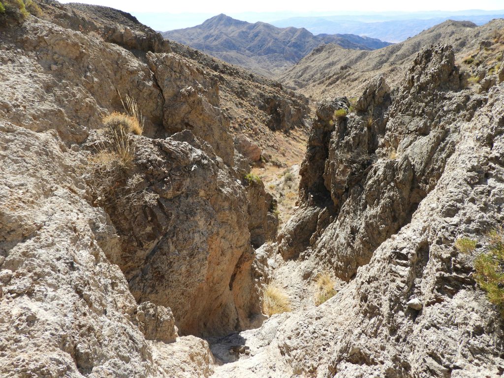 The gorge was narrow, steep, and full of rough rock walls:
