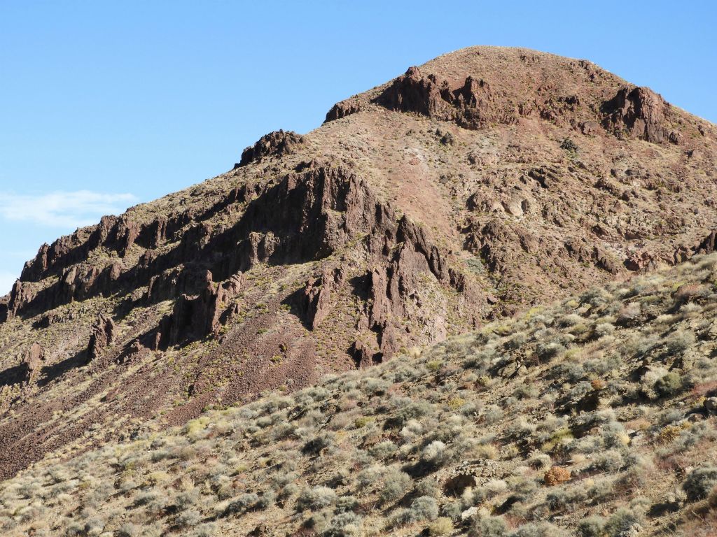 Check out the impressive red rock formations rising up out of this high hillside: