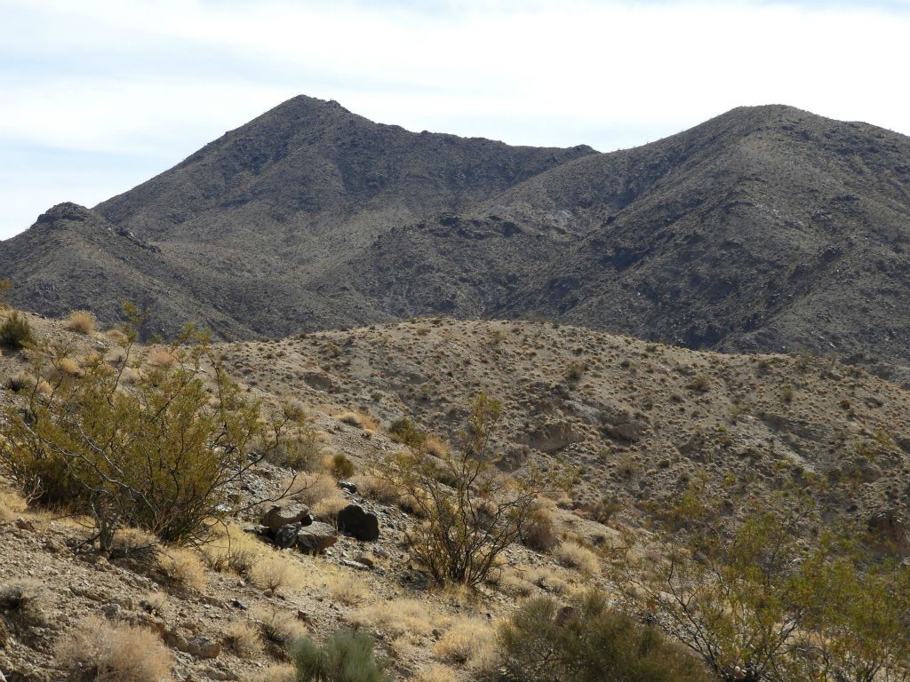 The slopes of Desert Hound Peak become more visible as progress is made down canyon: