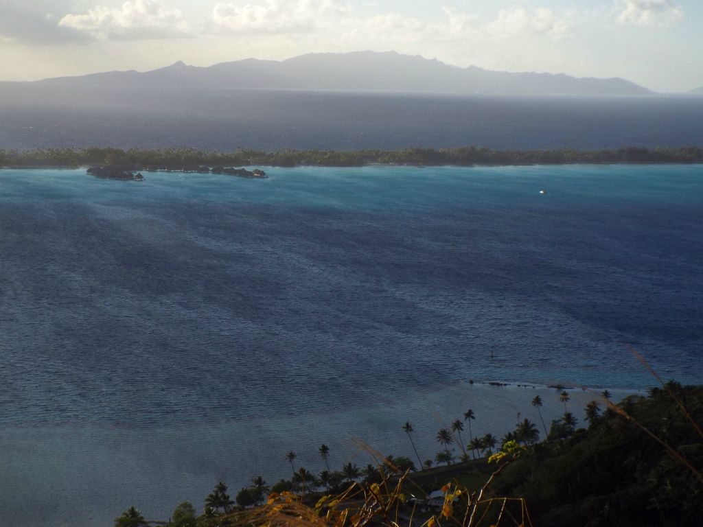 Looking to the southeast at the overwater bungalows of the Intercontinental Bora Bora Resort with the island of Tahaa in the background:
