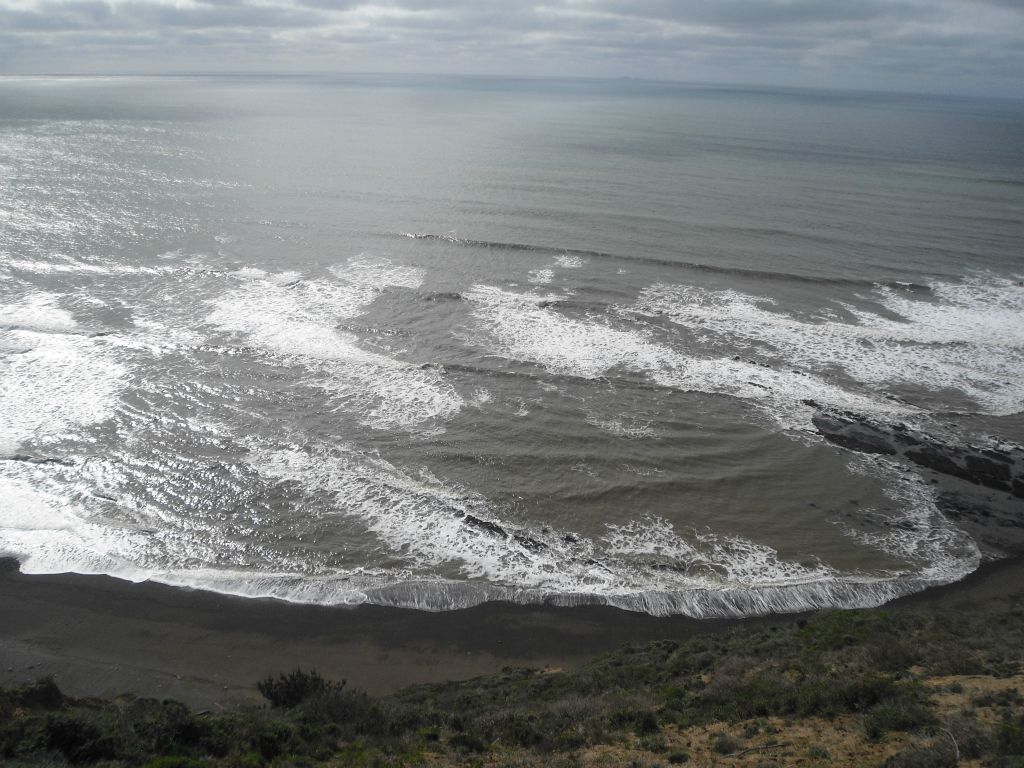 Looking out at the waves of the Pacific crashing into the shoreline: