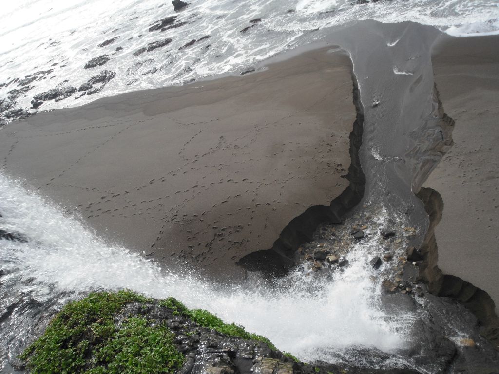 Looking down at the 40 foot drop of cascading water.  During high tide, the ocean water comes all the way up to the base of the cliffs: