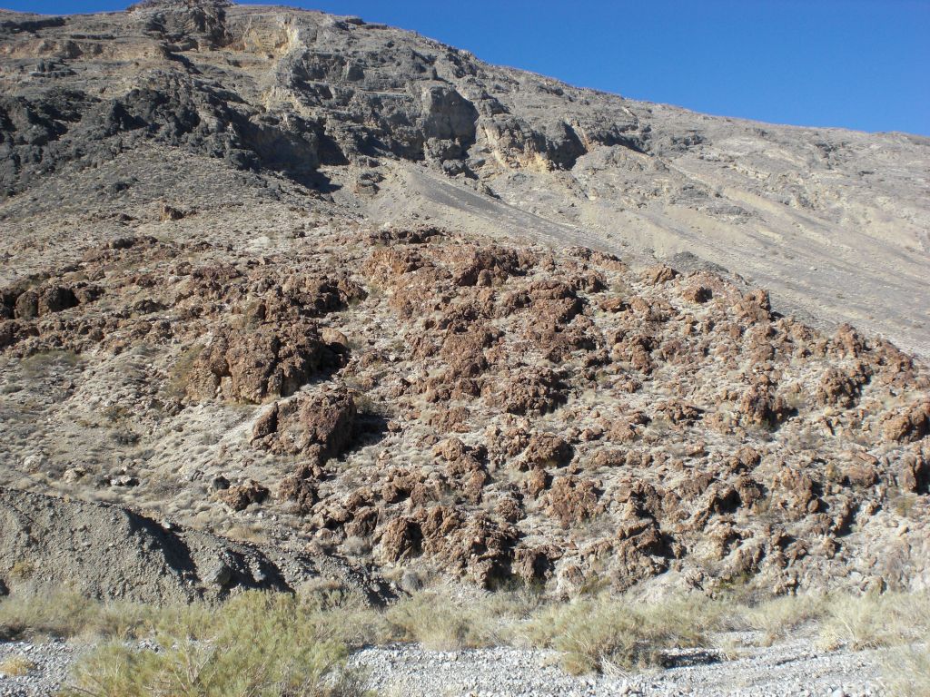 Pretty colored red rocks up on the hillside: