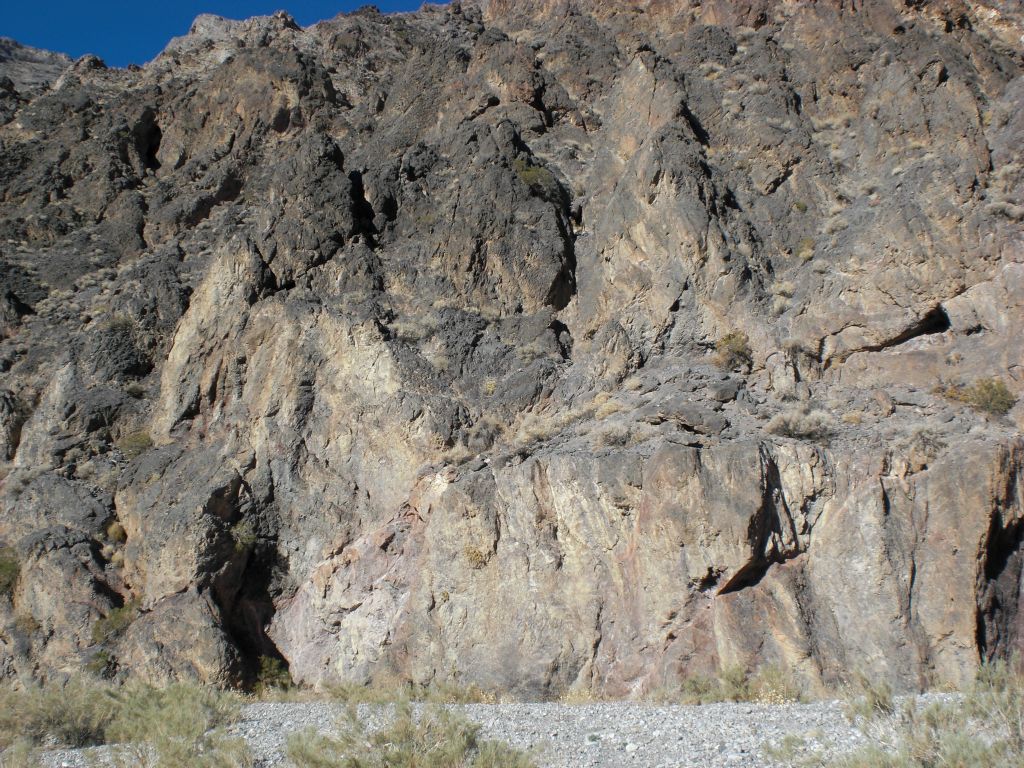 A change in scenery from sloping dirt hillsides to rock canyon walls: