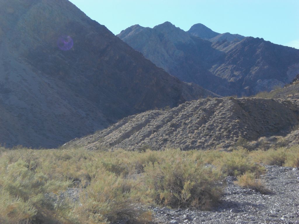 Working our way around a long dirt embankment that sloped down into the wash: