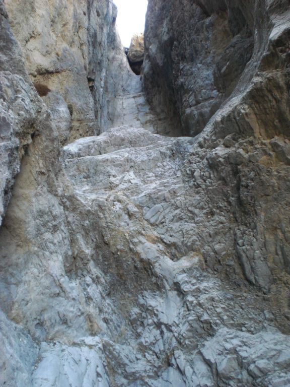 We walked a little closer and we could see that the 60 foot dry fall was topped by a chockstone.  (Not that we would have been foolish enough to try climbing it, anyway):