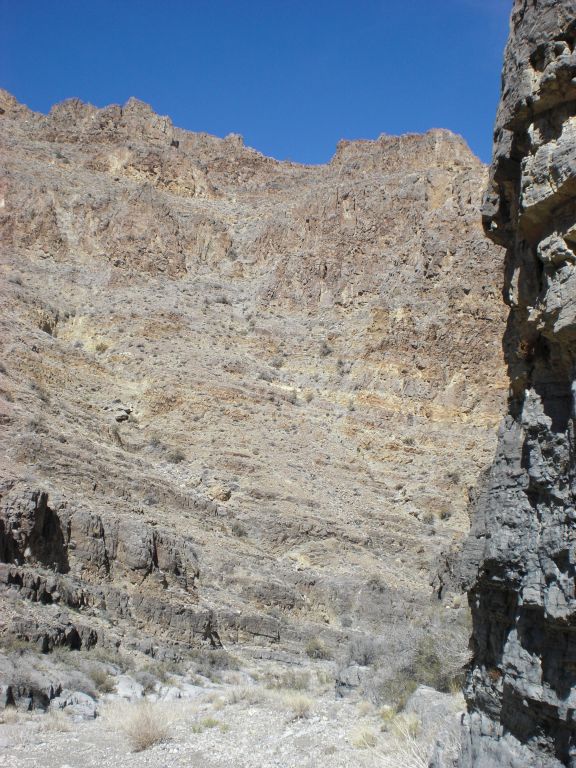 Stopping at the same spot to take a picture of the towering canyon walls and cliffs in the distance: