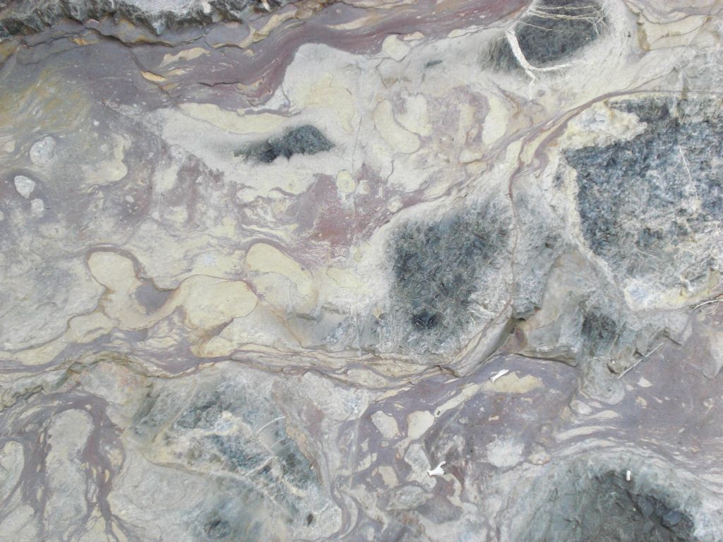 Odd patterns and colors on the surface of the rock: