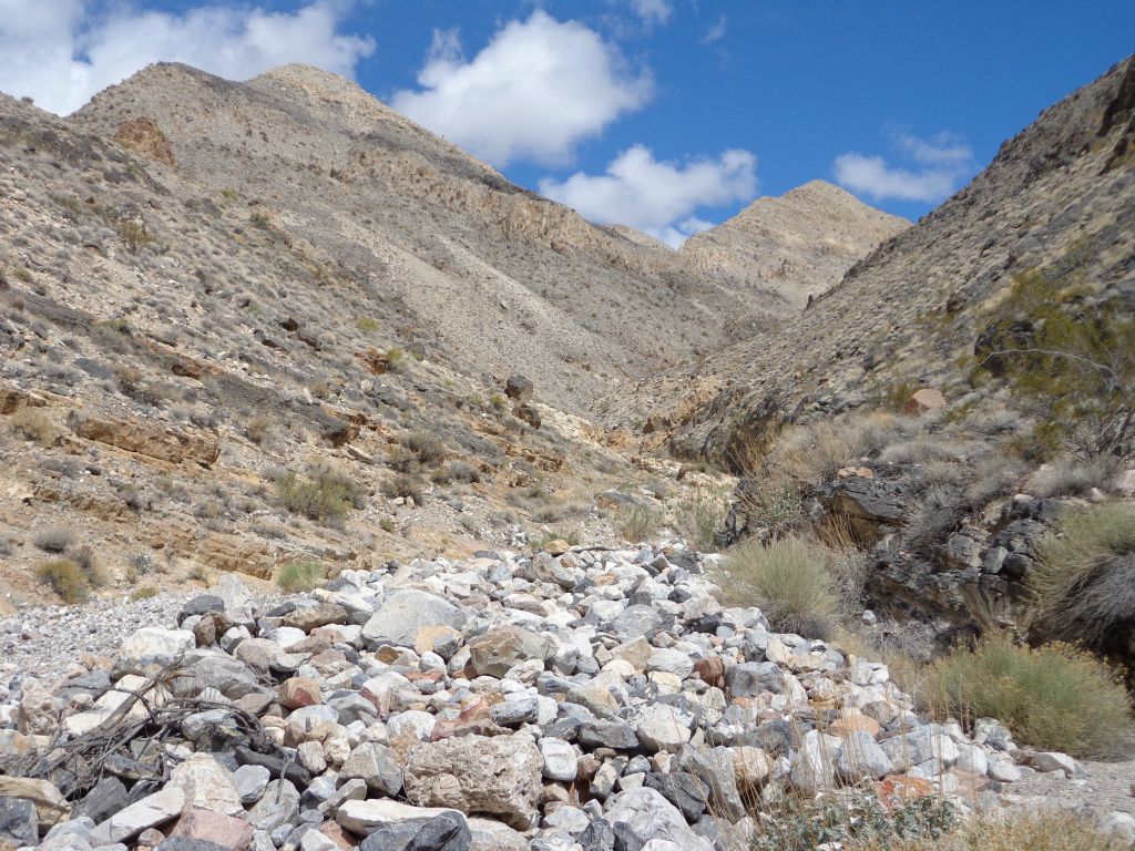 Past the 2nd side canyon, Dry Bone MSC cuts between two dirt hillsides: