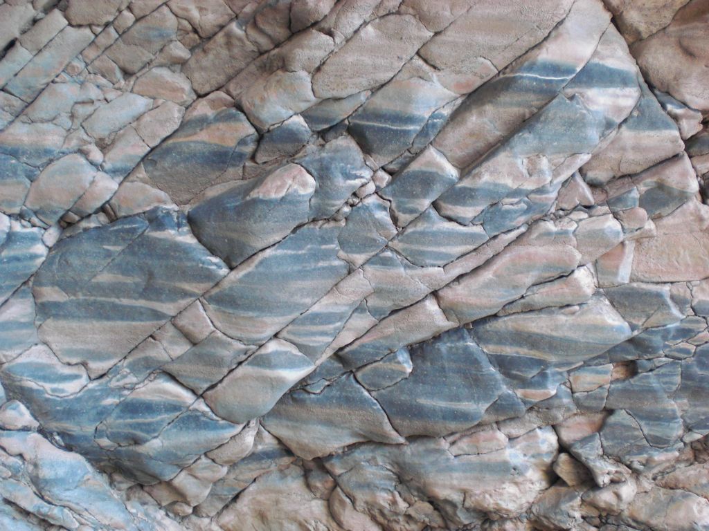 A close-up of the red and black rocks which make up the canyon walls in the narrows and the natural bridge: