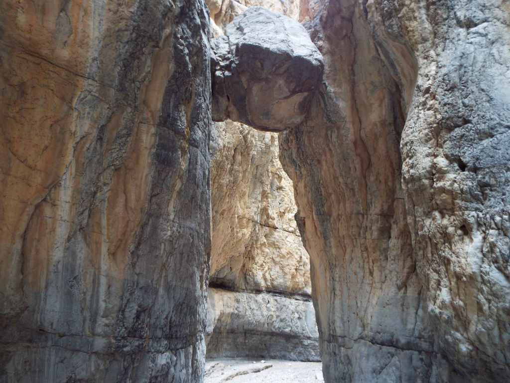 Heading back under the boulder and out of Lost Slot: