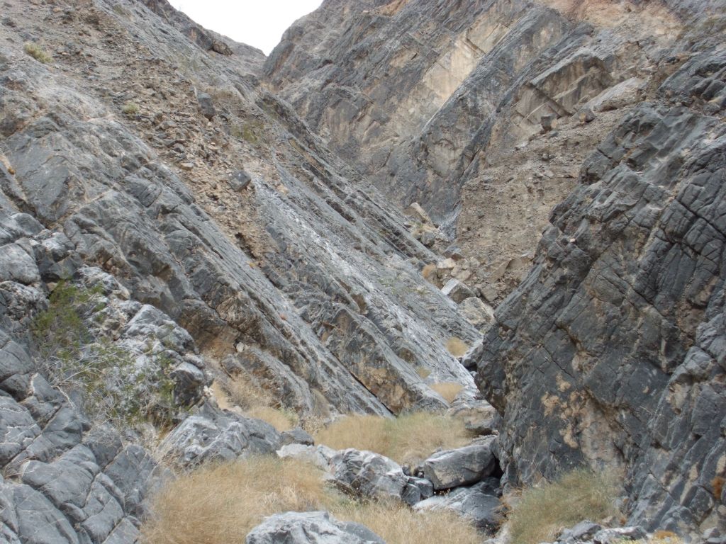 Up ahead we could see a spot where the rock slab high above the canyon came all the way down and touched the wash: