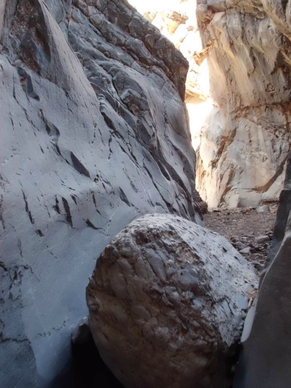 A positively beautiful spot with the canyon wall glowing and a boulder stuck between the narrow walls: