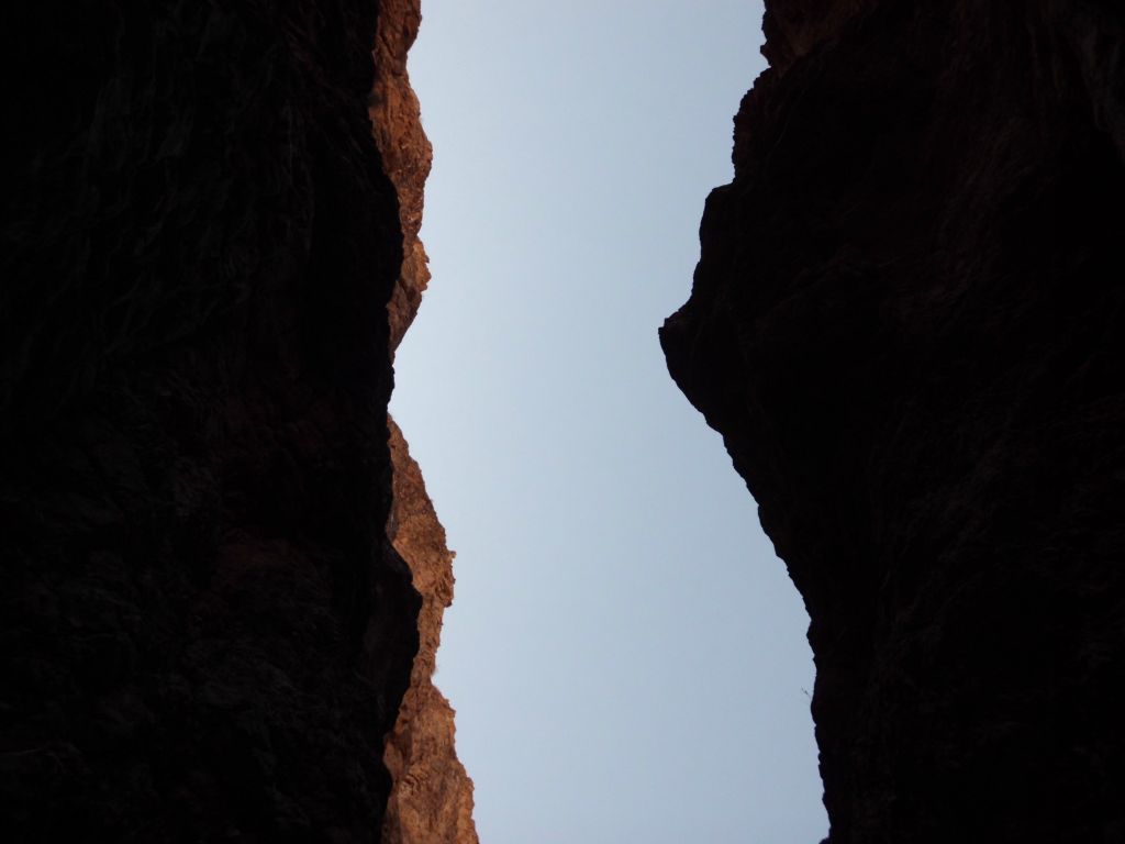 Looking high up above me to try to see out of the canyon in between the walls: