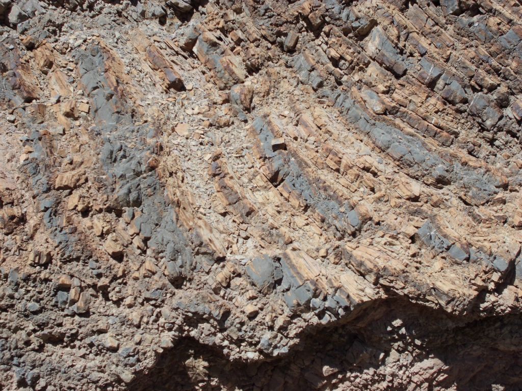 Stripes on the rock with pieces breaking away:
