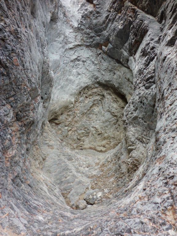 Looking down at the massive dry plunge pool that we passed by in the canyon: