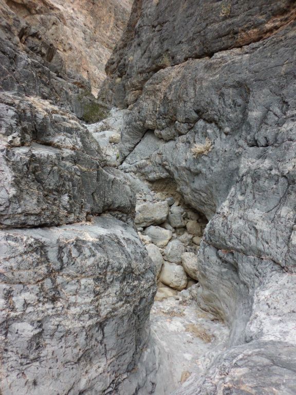 A narrow passage cuts a path directly through the rock: