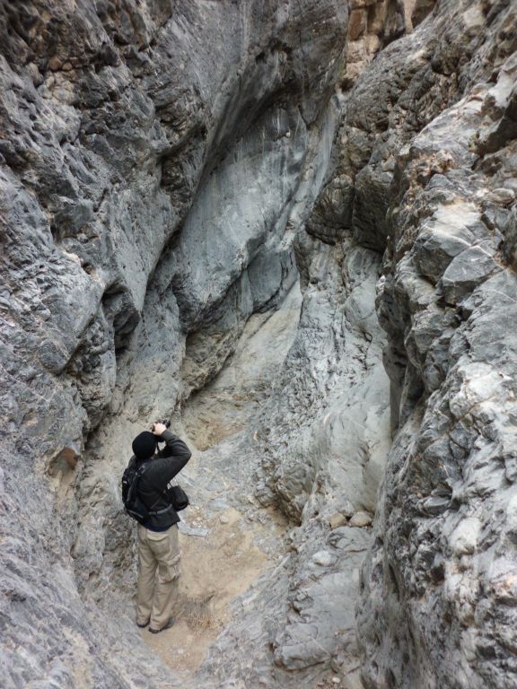 Tobin rounding a bend and taking a picture.  Notice here that the height of the narrows really encloses a hiker: