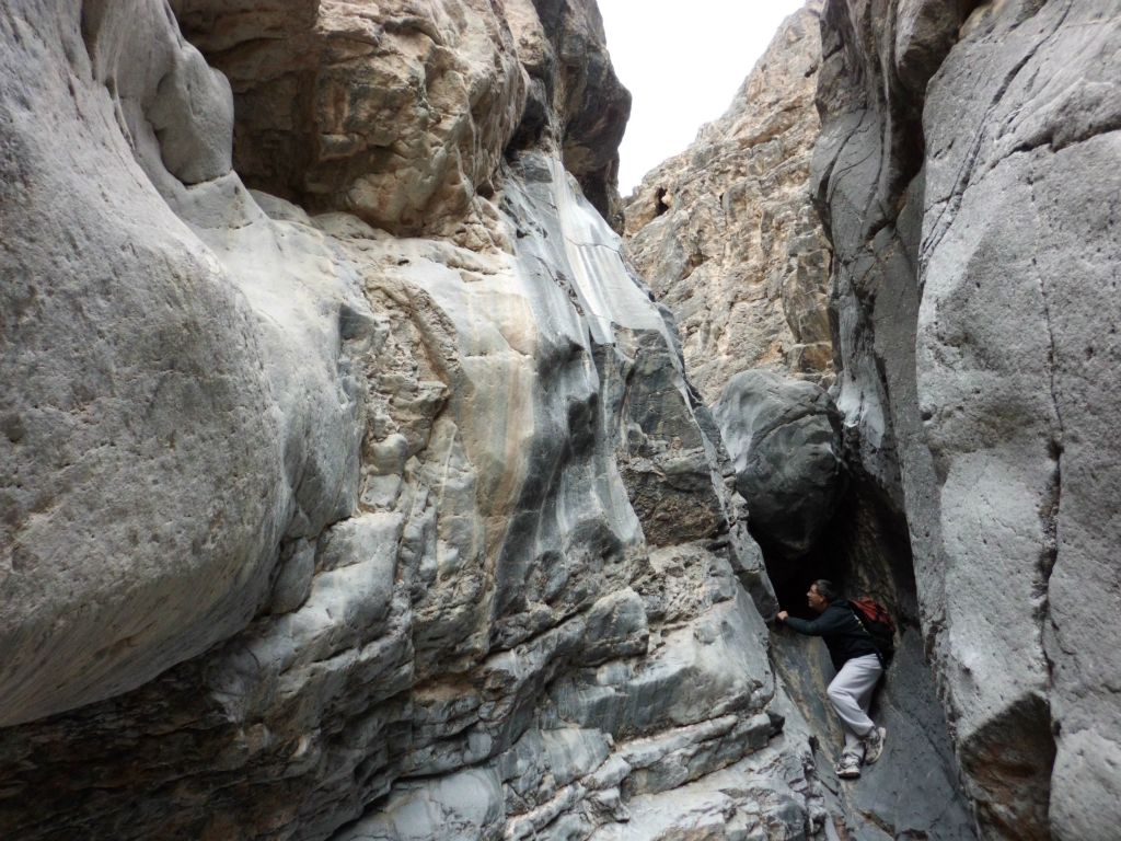 Patrick scouting around for a way up the boulder: