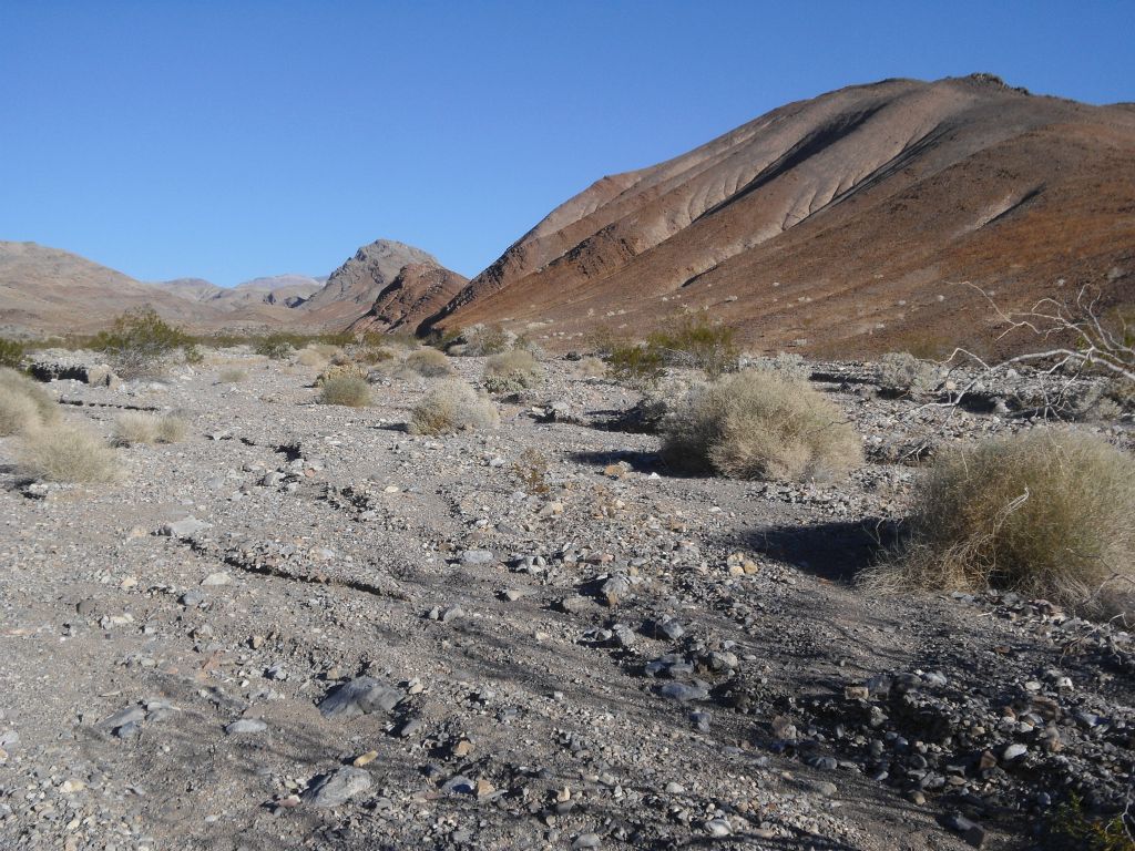 Heading up the wash while following red hillsides to our right:
