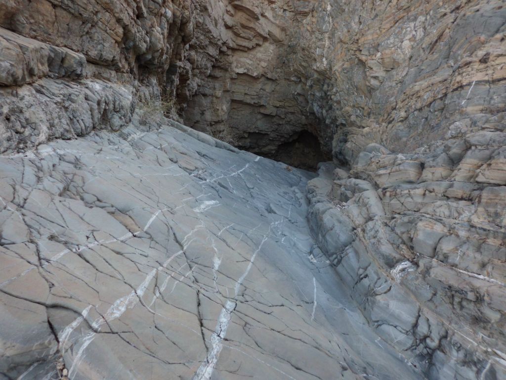 Once we got back into the canyon, we hiked back to the top of the 3rd major dry fall and took this picture of the polished chute. Earlier we had been in the enclosed grotto below this fall.  The grotto below looks like a dark abyss here:
