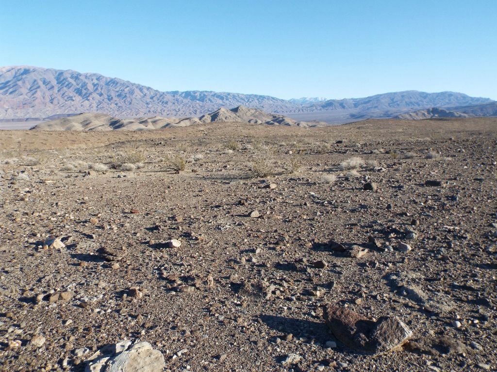 At the top of the hill, we could more clearly see the minor peaks rising up along the front of the range.  We were heading toward the left side of these minor peaks: