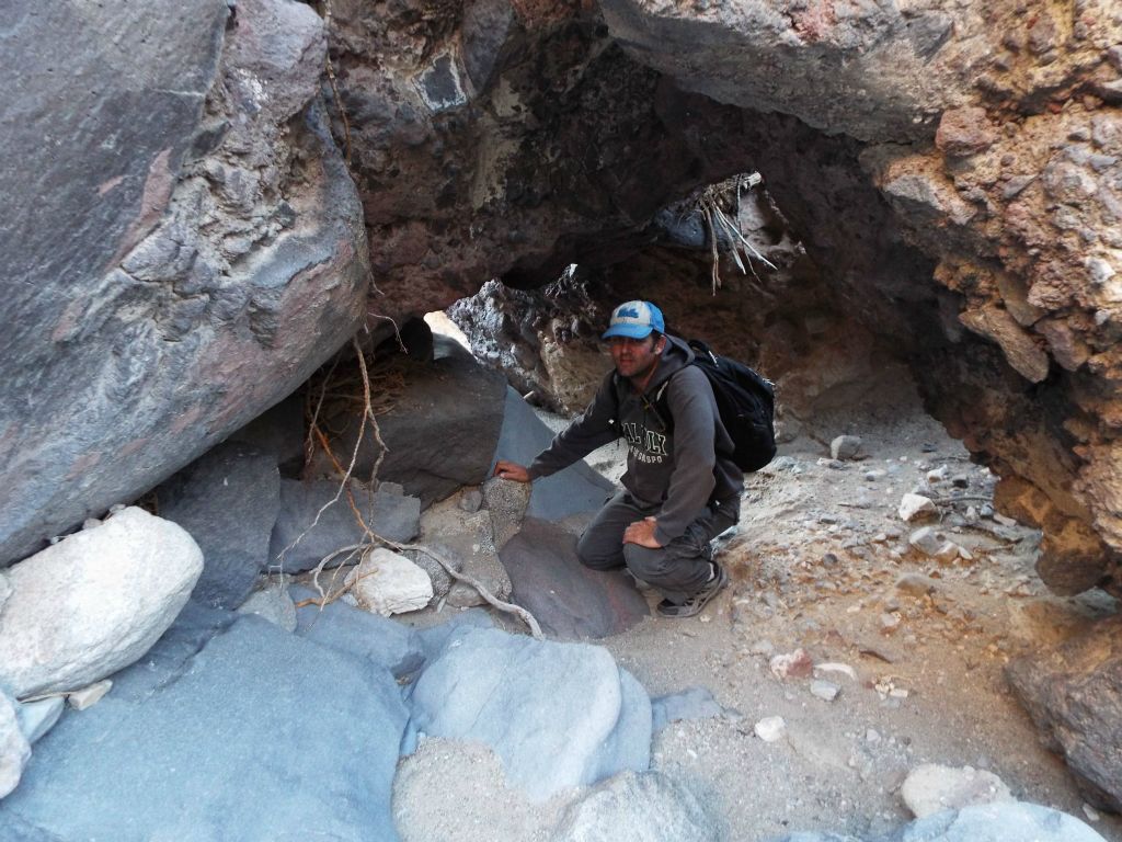 Crawling through passageways between the boulders in order to get past the blockade: