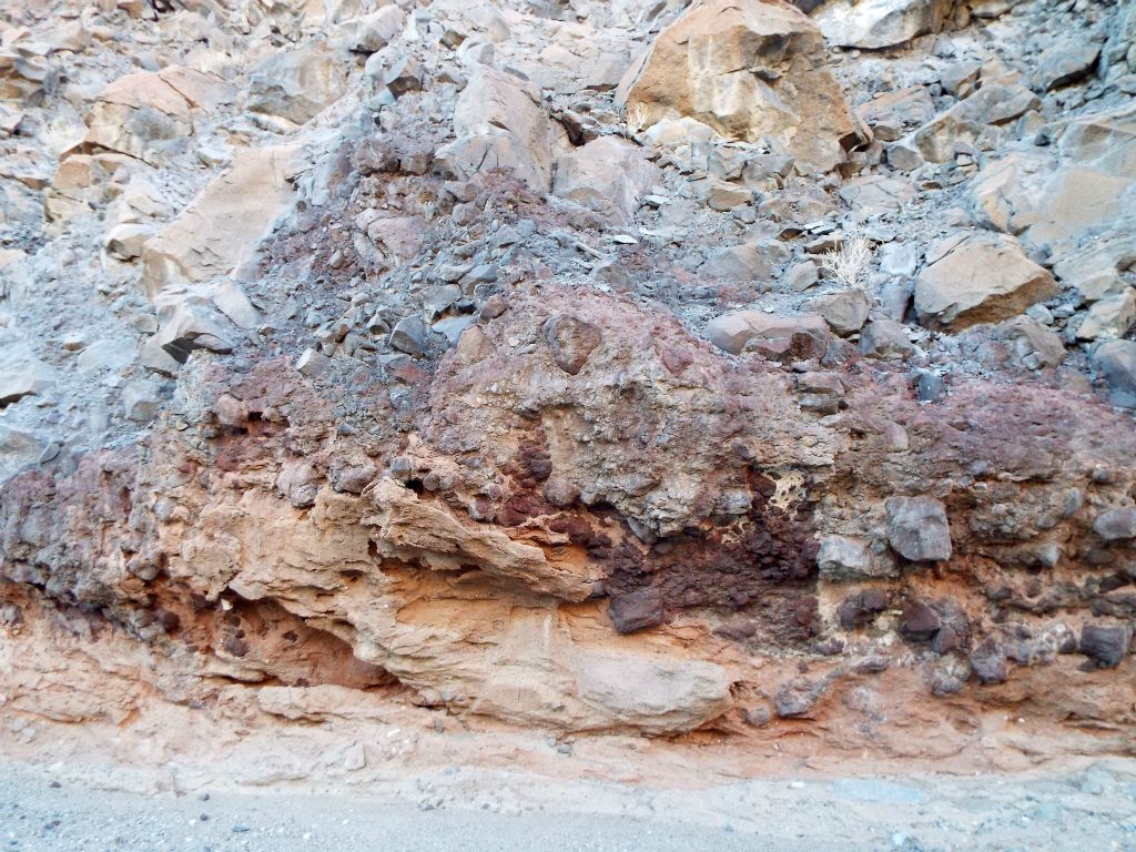 Just beyond, the canyon walls started to have colorful layers just below the rocky hillsides above: