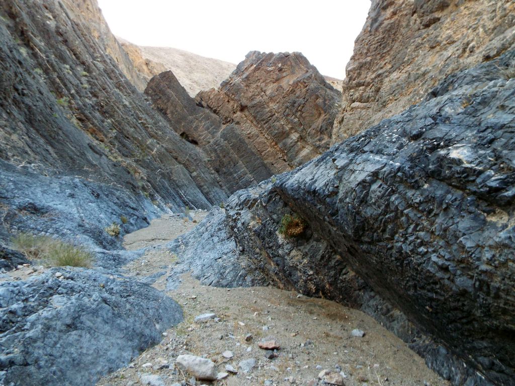 The curved lower wall on the right extends out from the hillside to help direct the water flow: