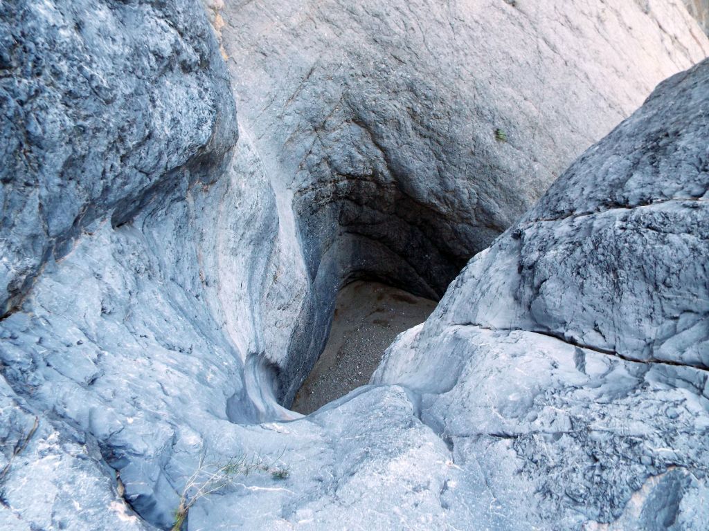 Around the next bend, the passable upper canyon ended at the rim of Pothole Falls.  This is the view down into the uppermost pothole: