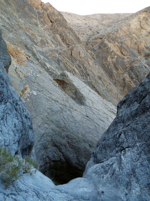 Portrait view showing the rim of Pothole Falls and the high canyon walls above the major dry fall.  This was all we could see of Pothole Falls: