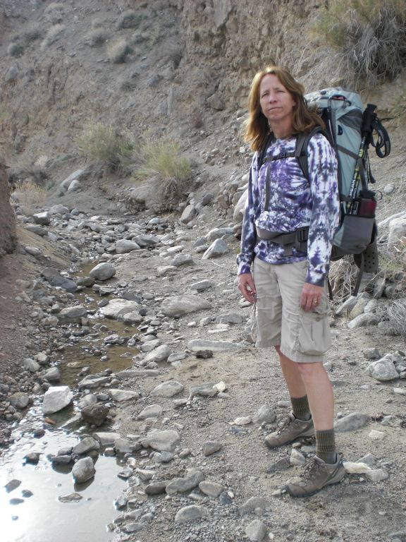 Kathy stopping near the place where we first spotted water coming downstream from Cottonwood Spring (the Upper spring):