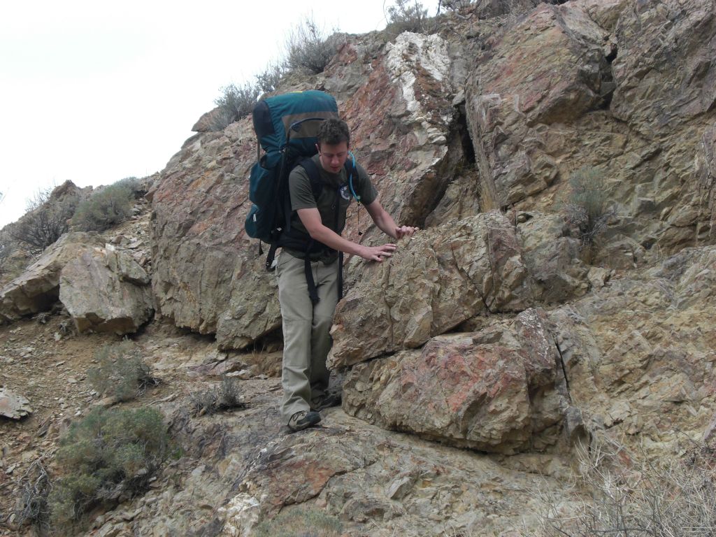 The brush was quite thick, so we had to make our way around it whenever possible.  In this picture, Brandon is crossing around a rock to avoid hiking in the brush on the canyon floor: