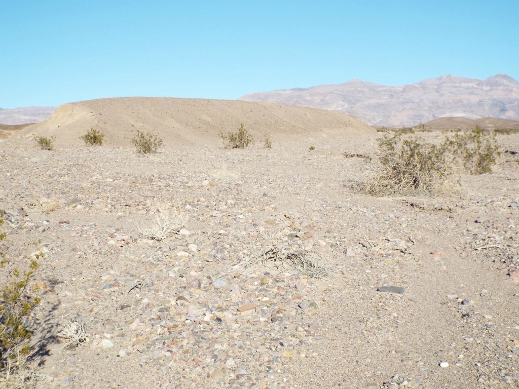 The hike begins by heading straight up a nondescript wash.  The key at the beginning of the hike is to stay to the right of the hillside outcropping seen here on the left:
