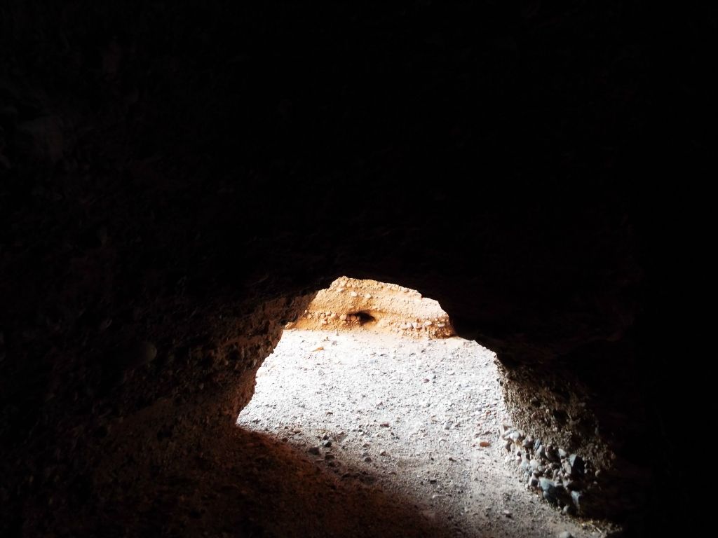 The two options to continue are to walk through the left side bridge or crawl through the right side bridge.  Once inside, the slot canyon turns dark: