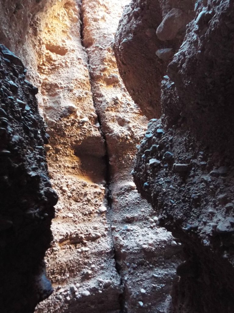 Zooming in on the crack down the canyon wall and the various colors on display: